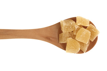 Dried pineapples cubes in  wooden spoon isolated 