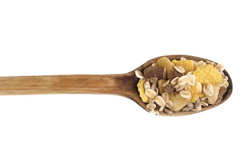 Muesli in wooden spoon from top on white background