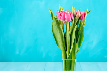 Wet Pink Tulip Flowers In Vase On Turquoise Table