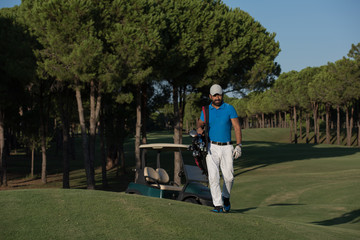 golfer  walking and carrying golf  bag