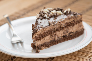 Slice of chocolate cake  garnished with nuts