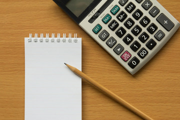 Calculator, notebook and pencil