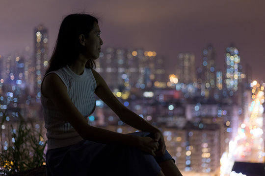 Woman enjoy the city view in Hong Kong at night - Powered by Adobe