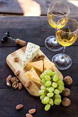 Wine, grapes, nuts, cheese, blue cheese. Dinner, lunch, romantic date, picnic, eating on nature.