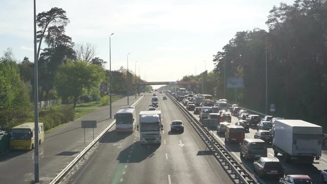 Traffic jam at sunset, long line of cars waiting to leave the city, summertime
