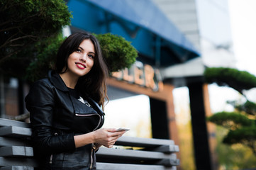 Fototapeta premium Smiling woman sending sms on the street