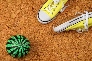 yellow sneakers on a background of cork