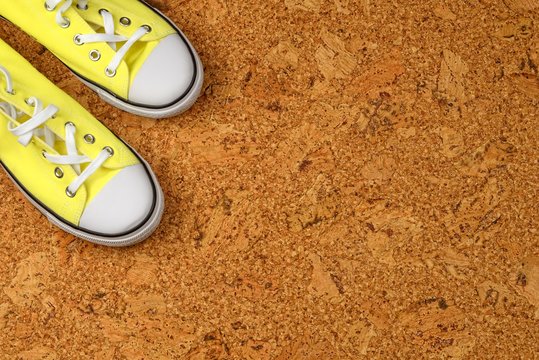 Yellow Sneakers On A Background Of Cork