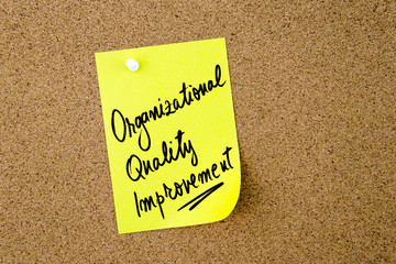 Organizational Quality Improvement written on yellow paper note