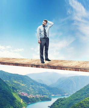 Man on the bridge above the mountain river