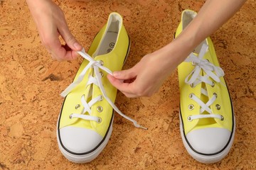 yellow sneakers on a background of cork