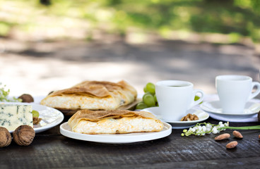 Сheese pie, strudel with cheese, cheese pie 4. Wine, grapes, nuts, cheese, blue cheese, and coffee. dinner, lunch, romantic date, picnic, eating on nature.