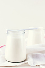 organic dairy products (yogurt, sour cream) in a glass jar