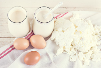 natural yoghurt in a glass jar, eggs and cheese. ingredients for baking