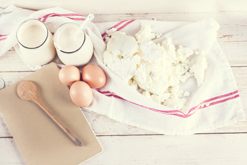 natural yoghurt in a glass jar, eggs and cheese. ingredients for baking