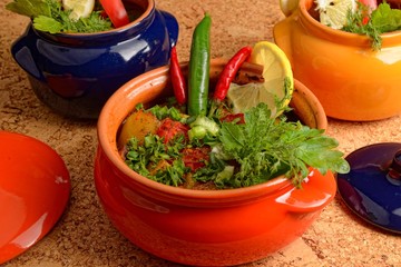 steamed vegetables in a ceramic dish on a cork background