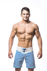 Fototapeta premium Sexy athletic man showing muscular body and sixpack abs, isolated over white background. Strong male nacked torso