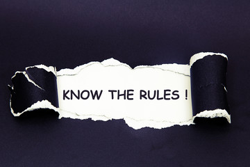 The text KNOW THE RULES! behind torn black paper
