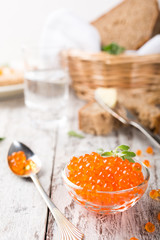 Glass bowl with red caviar