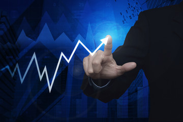 Businessman pointing to arrow business chart and graph over map