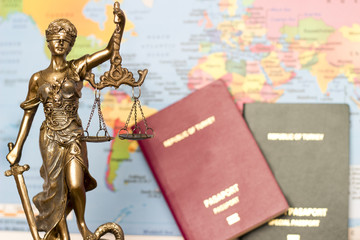 Law concept, statue, magnifying glass, passport and world map. Travel