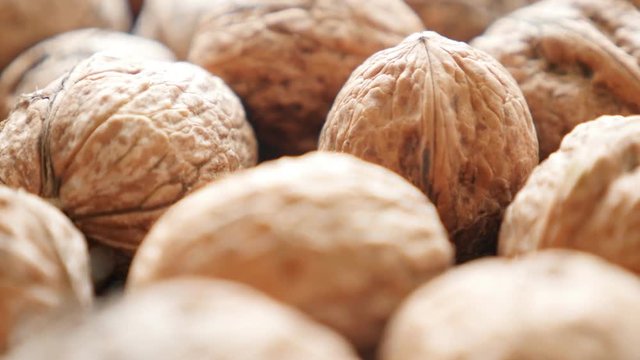 Walnut fruit pieces arranged on the table slow tilt 4K 2160p 30fps UltraHD video - Raw food background of seed of drupaceous nut 4K 3840X2160 UHD tilting footage 