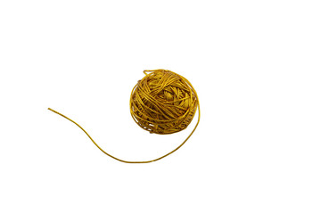 macro ball of threads for needlework of gold color isolate on a white background
