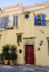 Decoration wall of a building in the form of small sculptures of people, the old city, Tel Aviv, Israel
