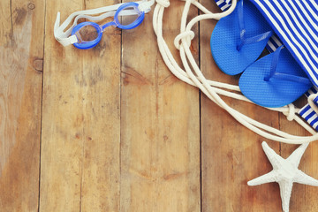 top view of beach accessories on wooden deck