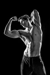 Strong man showing perfect abs, houlders, biceps, triceps and ch