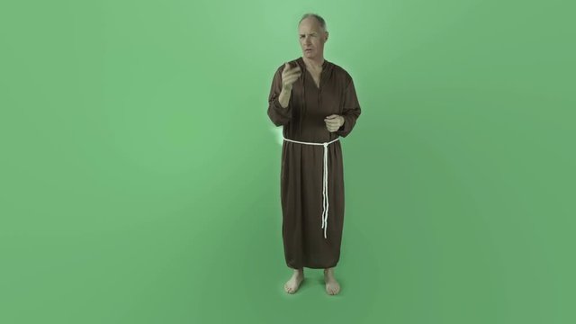 Senior caucasian monk isolated on chroma green screen interview talking