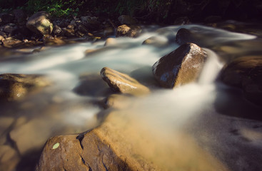nice beautiful mountain stream with green stones. Retro color.