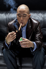 young businessman lighting a cigar.