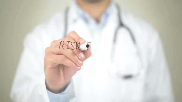 Risk Factors , Doctor writing on transparent screen