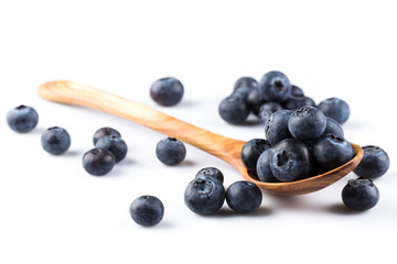 Fresh blueberries in wooden spoon