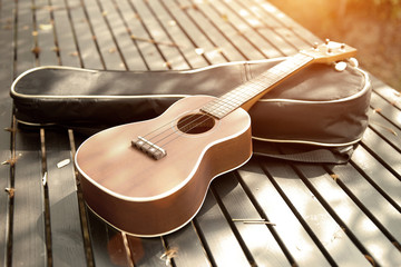 ukulele on a wooden table with a light vintage.