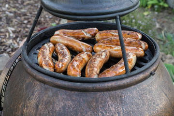 BBQ with sausages on the grill. Selective focus
