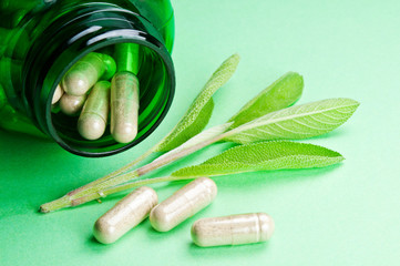 Sage leaves and sage pills.
Close up image of fresh sage leaves and sage tablets.
Herbal medicine...