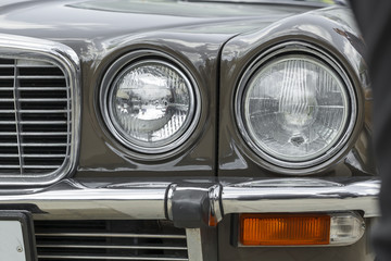 headlight and radiator front view of a retro car