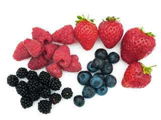 Assorted summer berries - strawberries, blueberries, blackberries etc on white