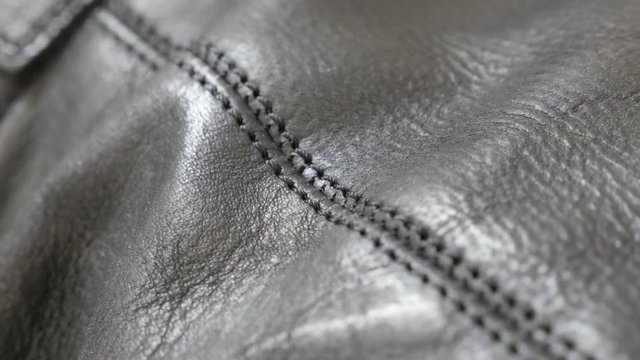 Leather texture and stitches of modern footwear slow tilt 4K 2160p 30fps UltraHD video - Shallow DOF of real leather surface close-up 4K 3840X2160 UHD tilting footage 
