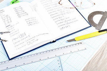 Naklejka na ściany i meble School supplies and textbook on mathematics close up