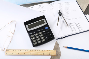 School supplies and textbook on mathematics close up