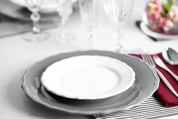 Table set at restaurant on light background