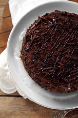 Tasty chocolate cake on wooden background