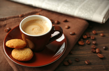 Cup of coffee on wooden table background