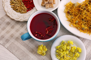 Cup of tea with aromatic dry tea on wooden background