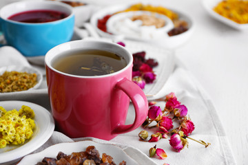 Cup of tea with aromatic dry tea on wooden background