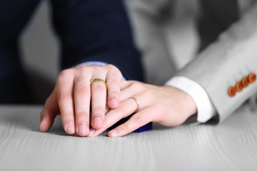 Two  homosexuals wearing wedding rings