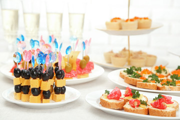 Set of cold snacks, canape, beverages, closeup